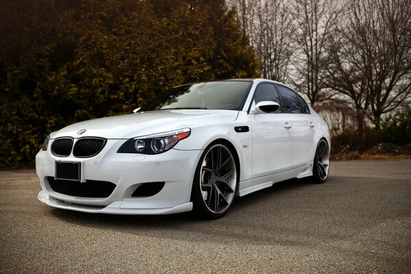 White BMW sedan tuning on the road