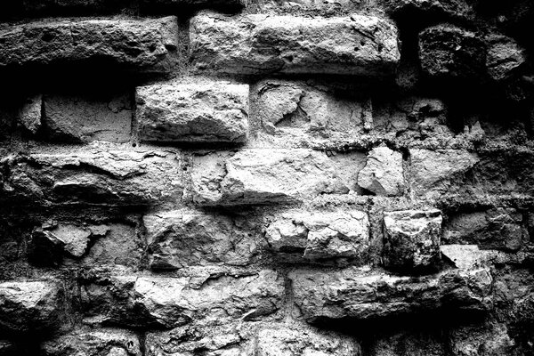 Photo en noir et blanc d un mur de briques