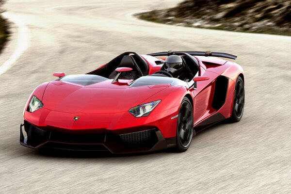 Red lamborghini aventador J -2012 on a sharp turn