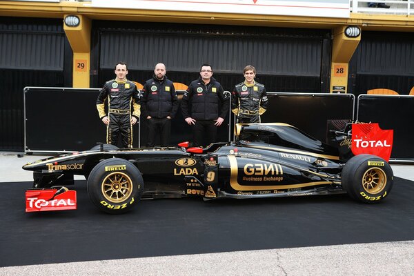 A team of racers next to a sports car