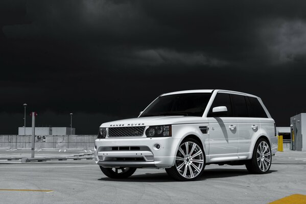 White land rover on a black sky background
