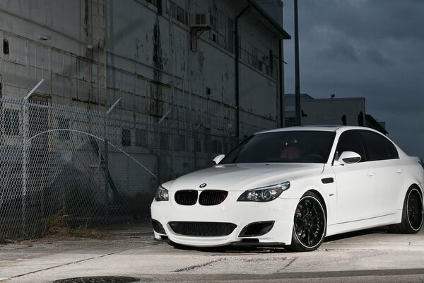 A white car parked at the fence