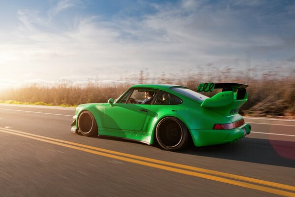 Tuned green Porsche 911 car on the road