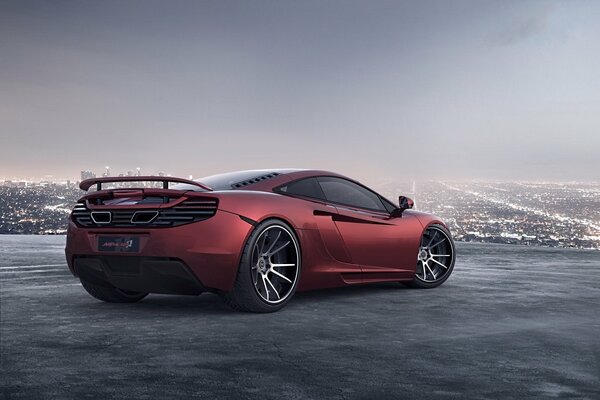 The red McLaren is standing on the platform, a big city is visible on the horizon
