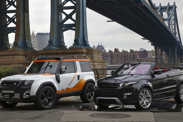Range rover convertible and land rover on the background of the bridge