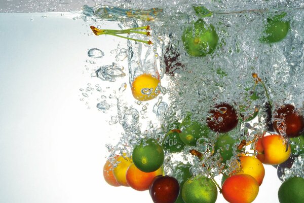 Lime, lemon, apricot fall into the water