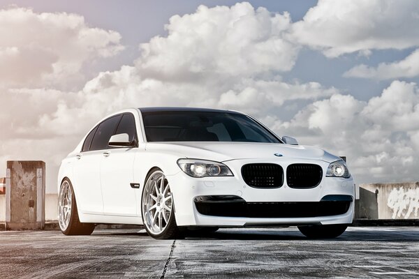 White BMW and cloudy sky