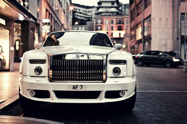 Prestigious white Rolls Royce in the urban landscape