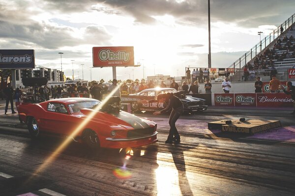 Red and black Ford Mustang at the races