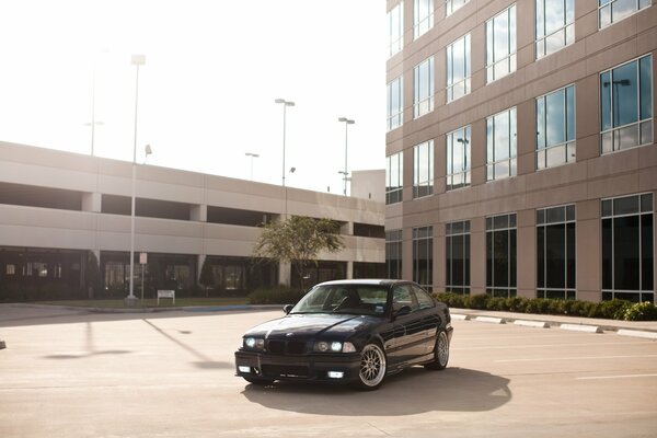 Car in the parking lot near the building black BMW