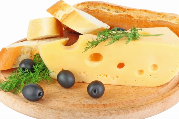 Slicing cheese with olives and baguette