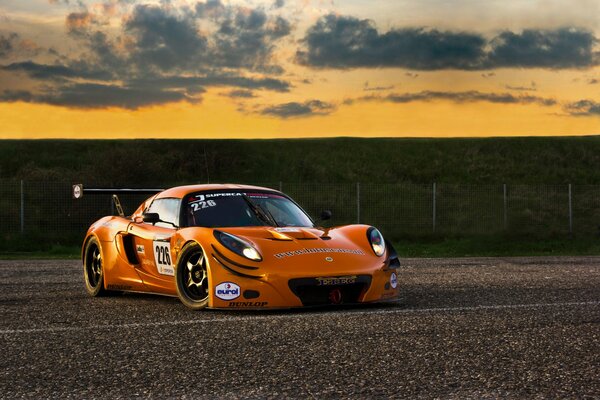 Orange sports car on a deserted track