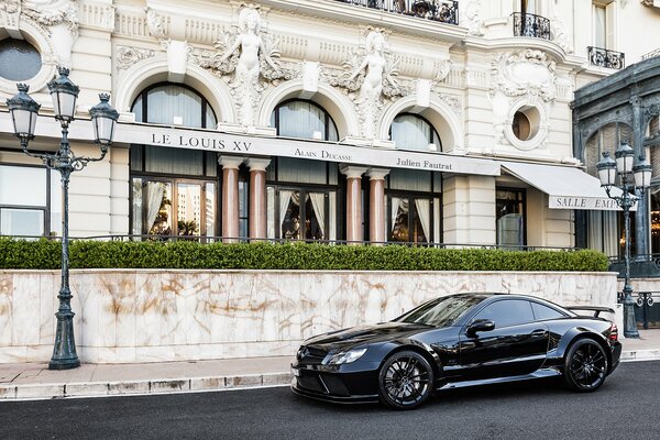 Black Mercedes driving over beautiful buildings