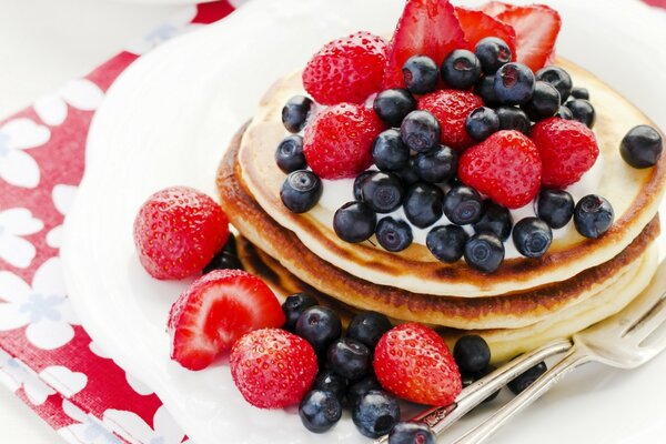 Pancakes with berries. Strawberries and blueberries