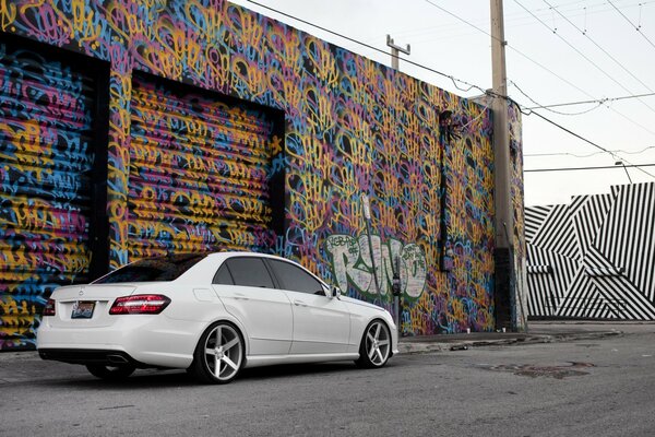 White mercedes e class on graffiti background