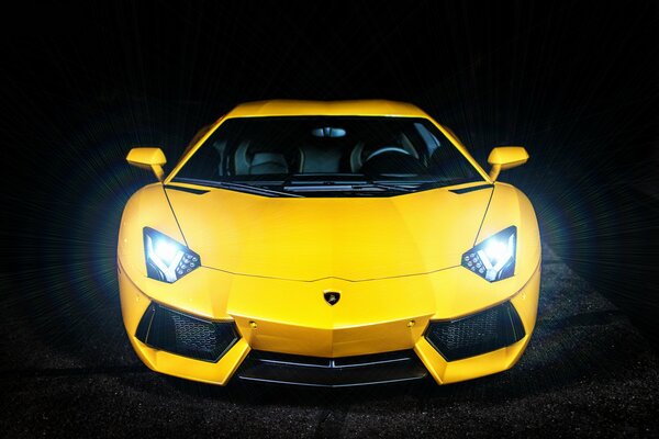 Yellow Lamborghini with low beam headlights on
