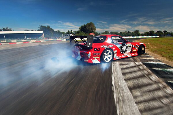 Drift rouge mazda rx-7 sur la piste