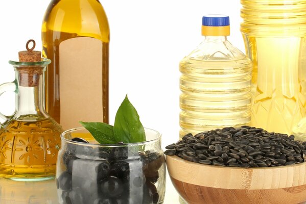 Bottles of oil seeds and olives