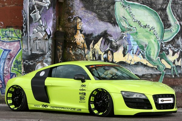 A new tuned Audi stands in front of graffiti