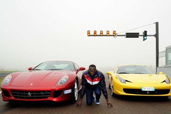 Athlete on the background of two cars