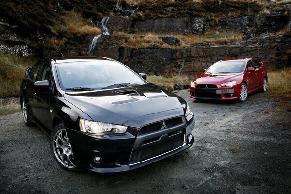 Two Mitsubishi cars red and black