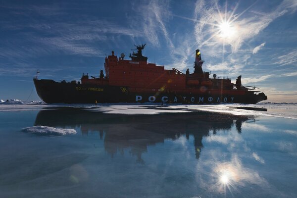 Nuclear icebreaker on the background of the blinding sun