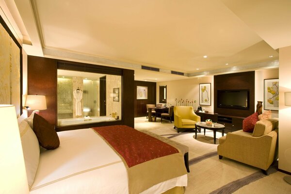 The interior of the suite is decorated in burgundy and beige tones
