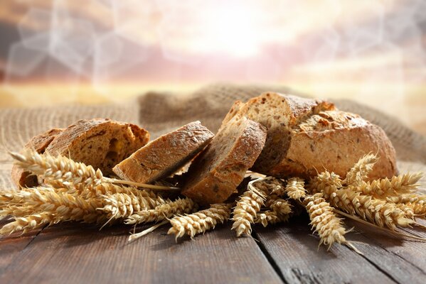 Fragrant slices of bread on the table with ears