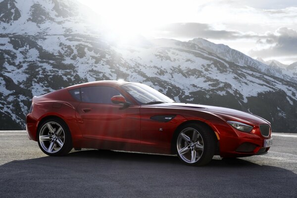 Red car with a long hood in the mountains