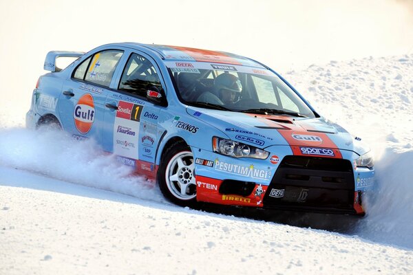 Mitsubishi evolution rally in a turn in the snow