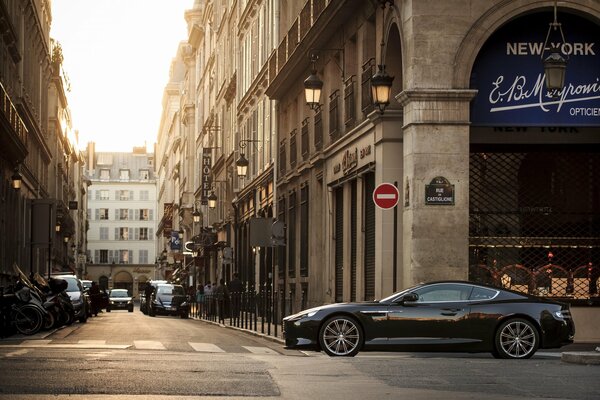 Elegant Aston Martin on the background of a street and a building