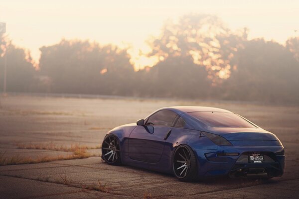 A lonely blue car on concrete