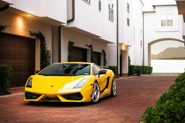 Yellow Lamborghini on the cobblestones at home