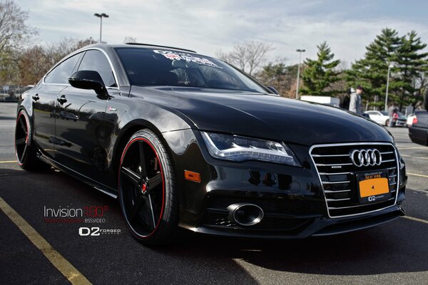 A black Audi a7 is parked in the parking lot