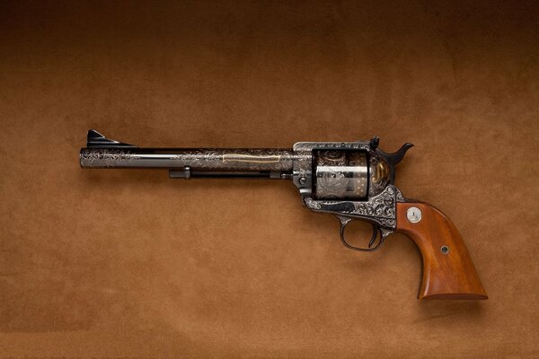 Colt revolver with engraving on a brown background