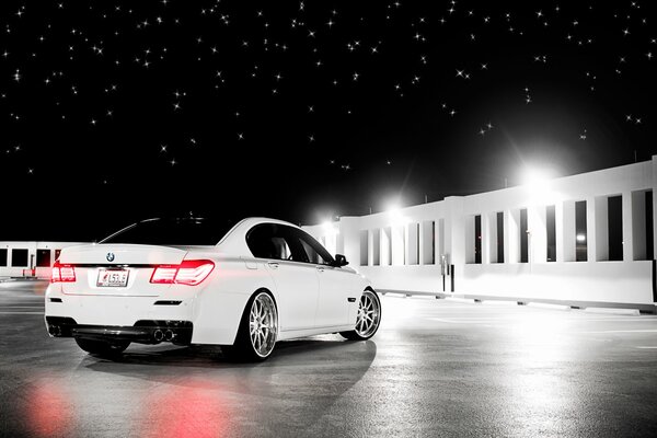 There is a white car and a beautiful starry sky around