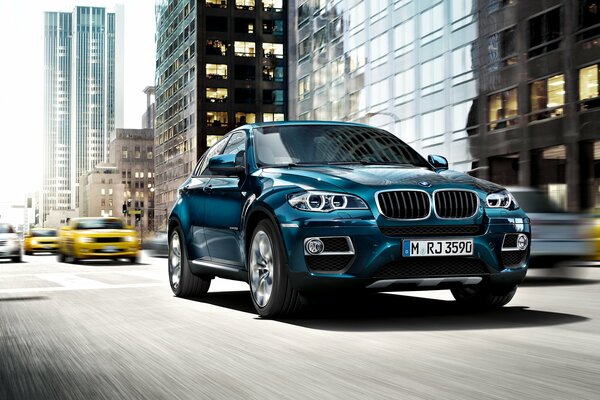 Blue bmw x6 drives around the city