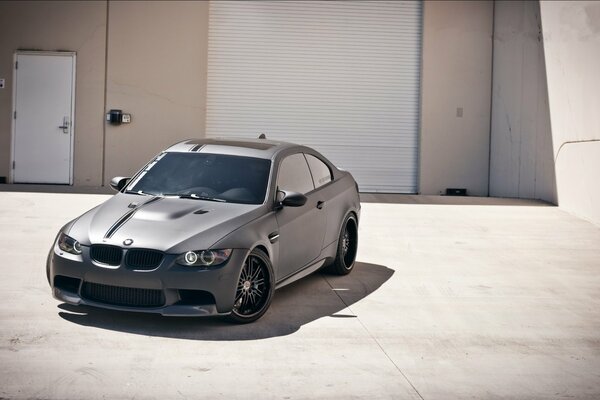 A gray car is parked at the garage