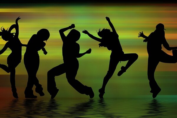 Silhouettes of dancing people on a bright background