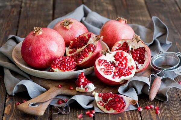 Pomegranate lying on a board and on a plate