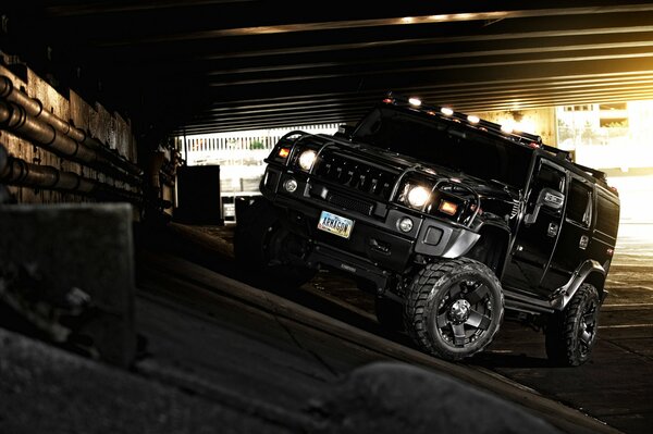 A black Hummer SUV pulled away from the road