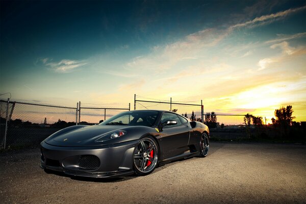 Sports car on the background of the setting sun