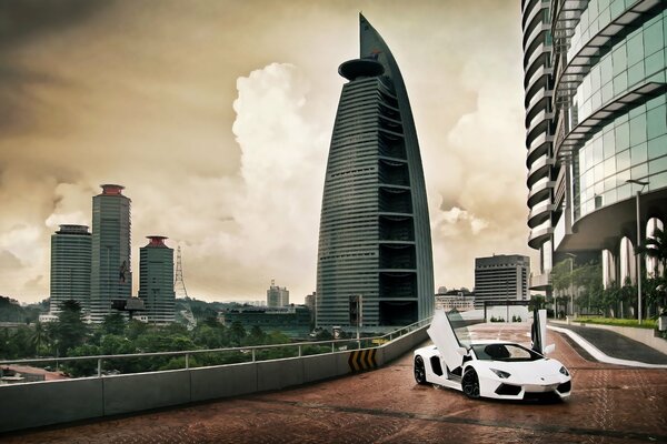 Sky and clouds over the city of Kuala Lumpur and on its background Lamborghini Aventador lp700-4