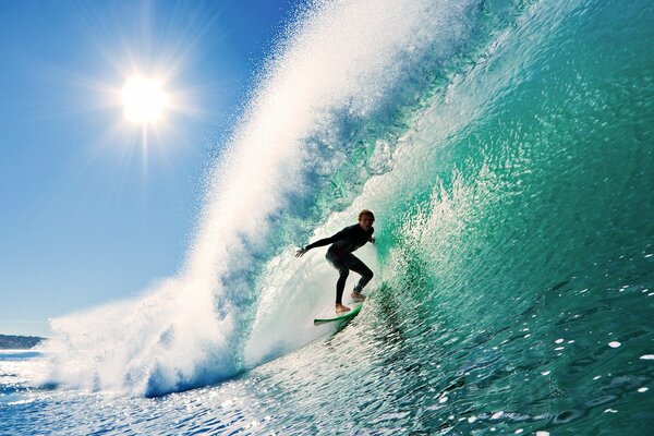 Surfer on a board and a huge wave