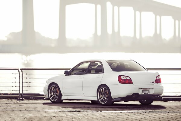 A car standing against the background of a river