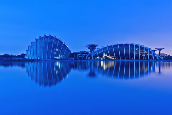 Beautiful modern buildings on a blue background with water