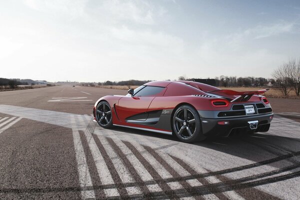 Red supercar on a deserted road