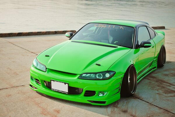 Green nissan silvia s15 at the pier