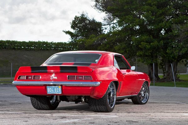 Red sports car with wide rear wheels