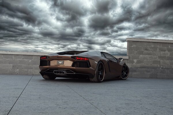 Lamborghini on the roof of the house in bad weather rear view